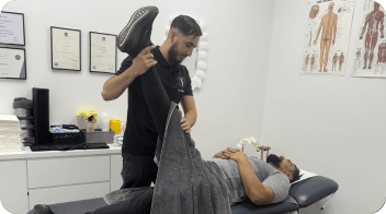 physiotherapist-treating-a-man-using-equipment-
